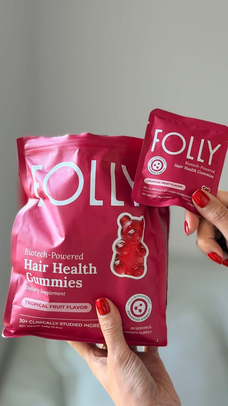 Folly Hair Health Gummies red packaging held by a person with red nails.