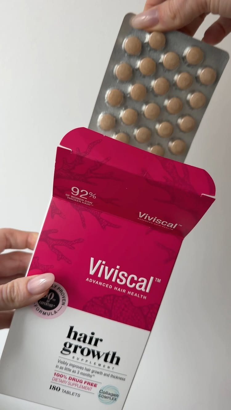 Viviscal hair growth supplement box and a blister pack of brown tablets.