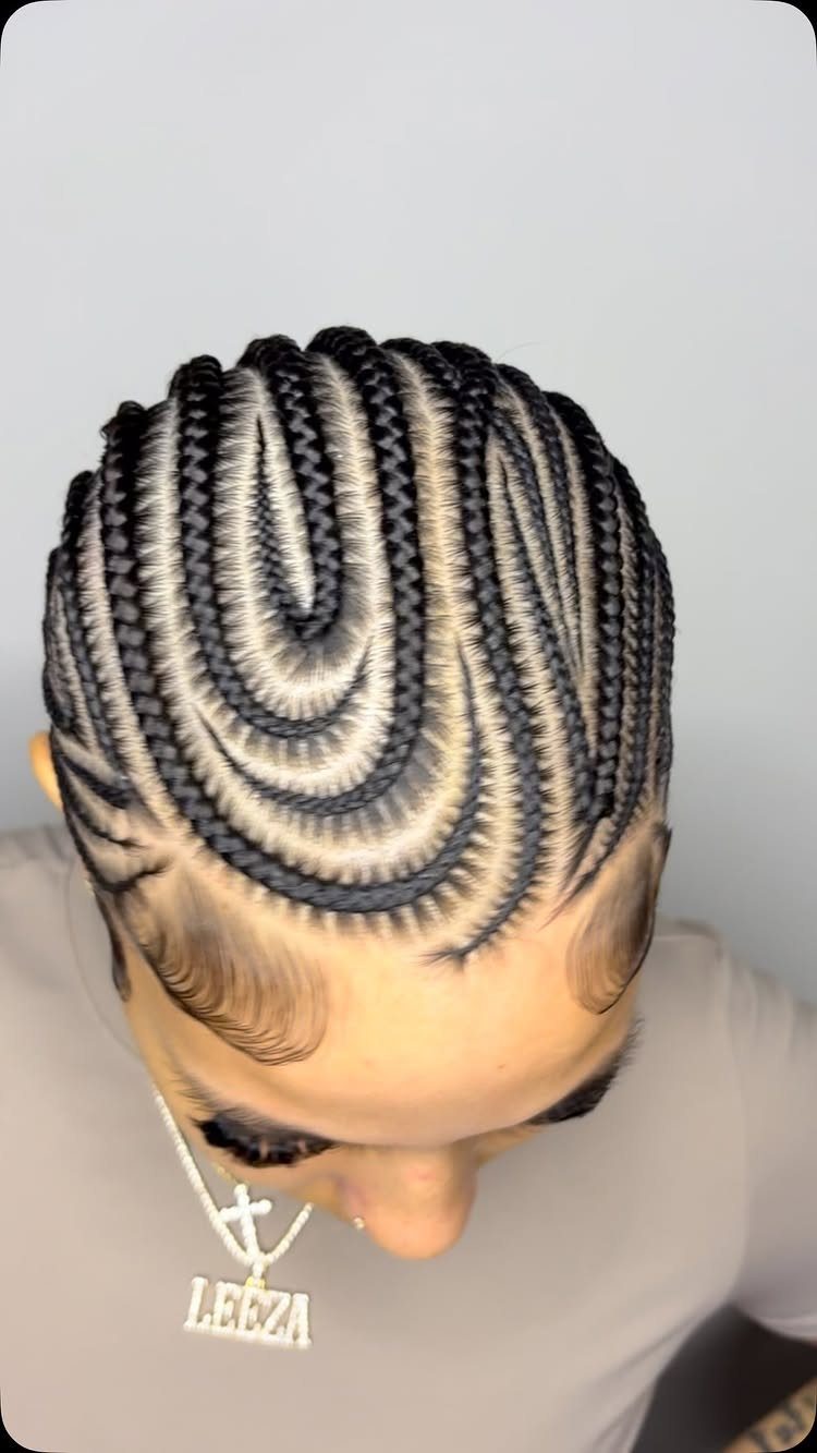 Intricate curved cornrow braids in black and blonde on a person's head.
