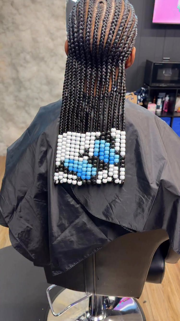 Black cornrow braids with white, blue, and black beads forming a pattern.