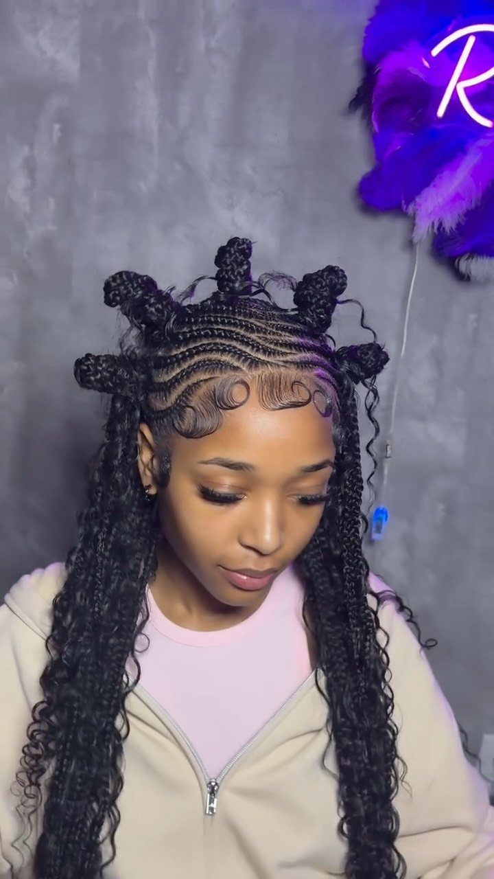 Woman with Fulani braids featuring cornrows on top and long curly braids below.