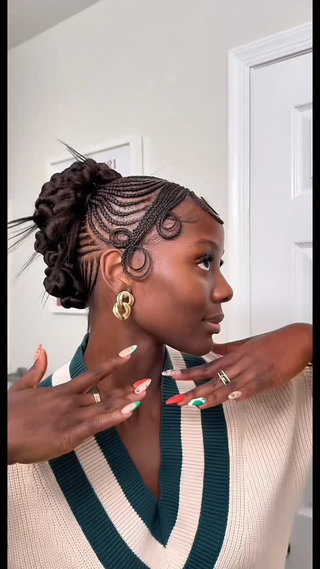 Woman with intricate scalp braids styled into a large braided bun at the back.